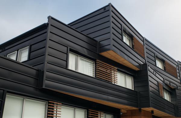 Colorsteel cladding lend durability and strength to this stylish apartment. Cantilevered apartment building